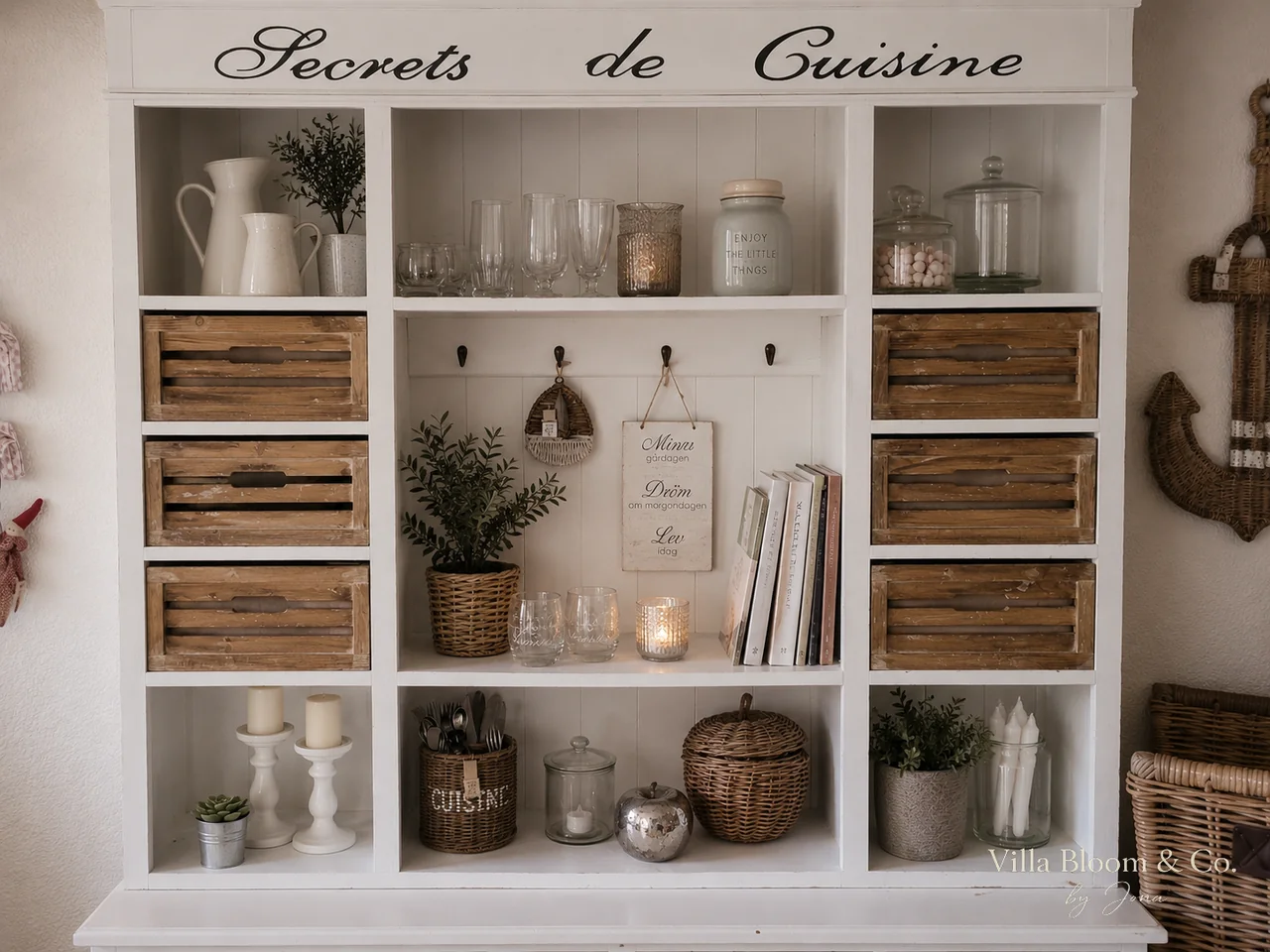 Open country-style shelf with Secrets de Cuisine lettering, wooden crates, white jugs, glasses and baskets in Riviera Maison style